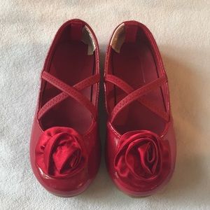 Red ballet style shoes with rose on toe. Size 7.